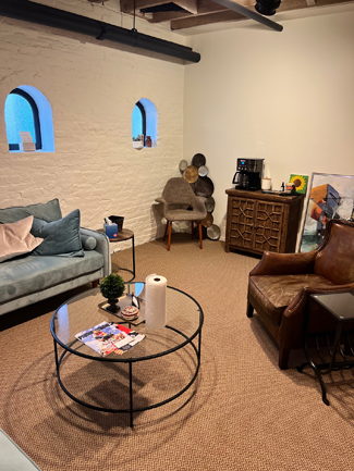 photo pasadena office, two arched windows, glass coffee table, grey sofa, tan leather chair